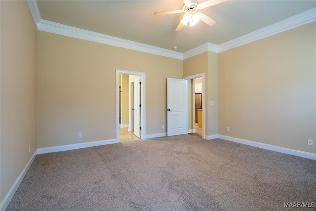 carpeted empty room featuring ceiling fan and ornamental molding