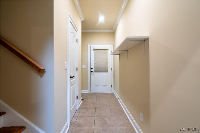 hall featuring light tile patterned floors and ornamental molding