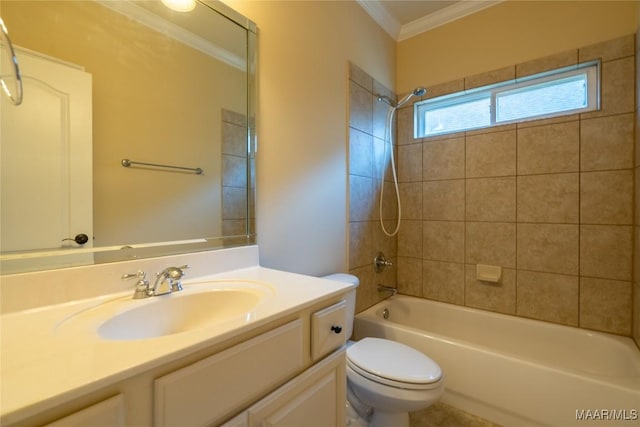 full bathroom with crown molding, toilet, vanity, and tiled shower / bath