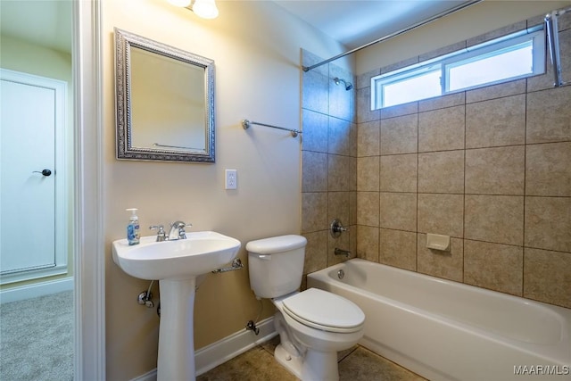 full bathroom with toilet, tiled shower / bath, and sink