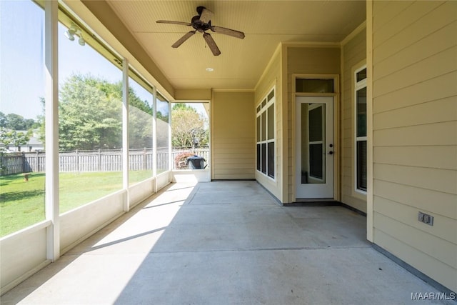 sunroom featuring ceiling fan