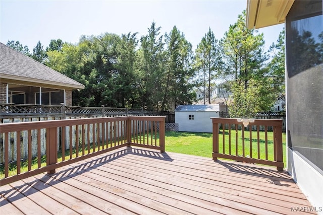 deck with a shed and a lawn