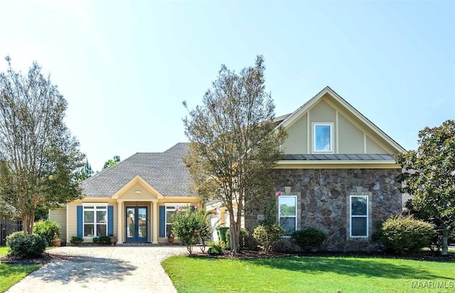 view of front of home featuring a front lawn and french doors