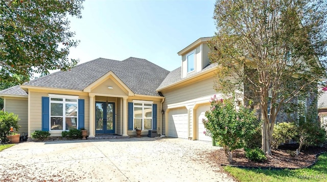 view of front of home with french doors and a garage