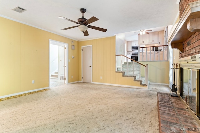 unfurnished living room with carpet flooring, ceiling fan, and crown molding