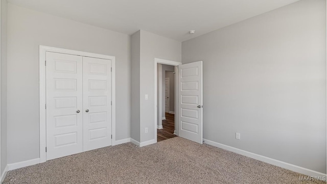 unfurnished bedroom featuring carpet and a closet