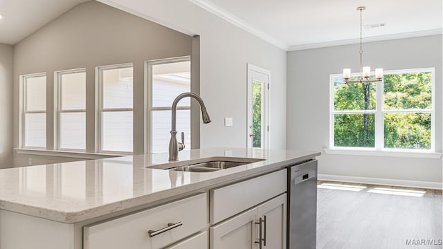 kitchen featuring light stone countertops, white cabinetry, a healthy amount of sunlight, and stainless steel dishwasher