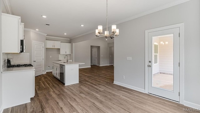 kitchen with a kitchen island with sink, white cabinets, hanging light fixtures, and dark hardwood / wood-style floors