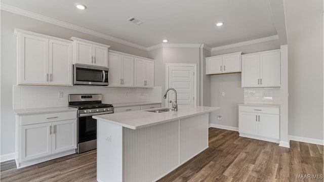 kitchen featuring stainless steel appliances, white cabinetry, a center island with sink, and sink