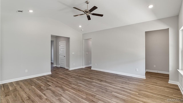 spare room featuring ceiling fan, hardwood / wood-style floors, and vaulted ceiling