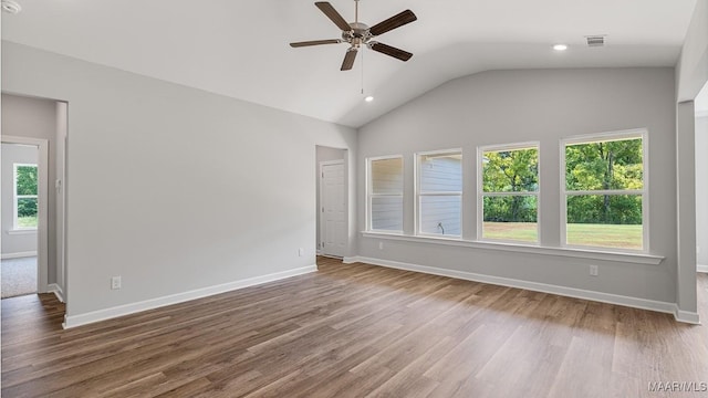 unfurnished room with hardwood / wood-style floors, vaulted ceiling, plenty of natural light, and ceiling fan