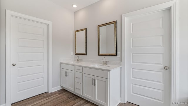 bathroom with vanity and hardwood / wood-style flooring