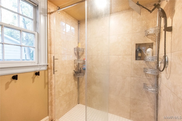 bathroom featuring a shower with door