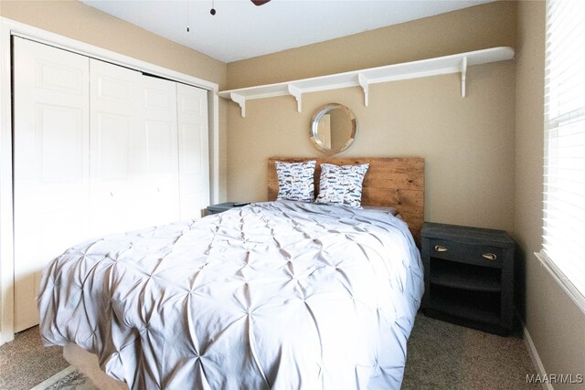 bedroom featuring ceiling fan, a closet, and carpet