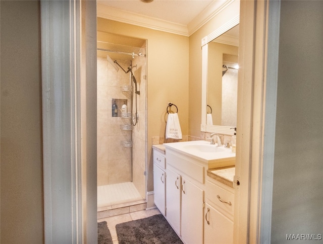 bathroom with vanity, tile patterned floors, crown molding, and tiled shower