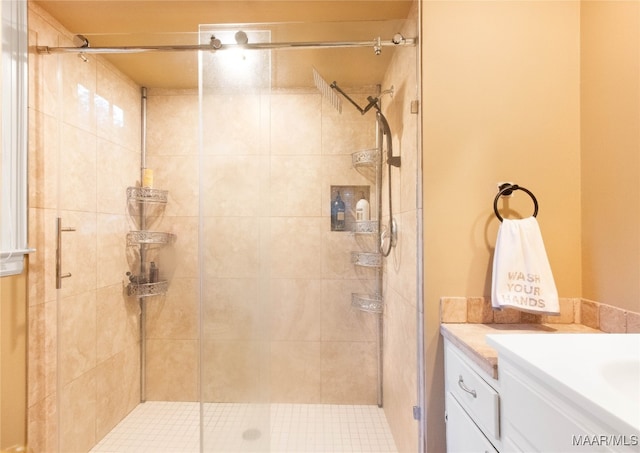 bathroom with walk in shower and vanity