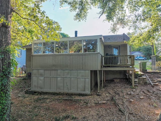 back of house featuring central AC unit