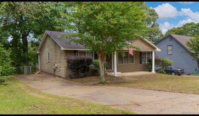 3033 Willow Lane Dr, Montgomery, AL 36109 - view of front facade featuring a porch, a front lawn, and driveway