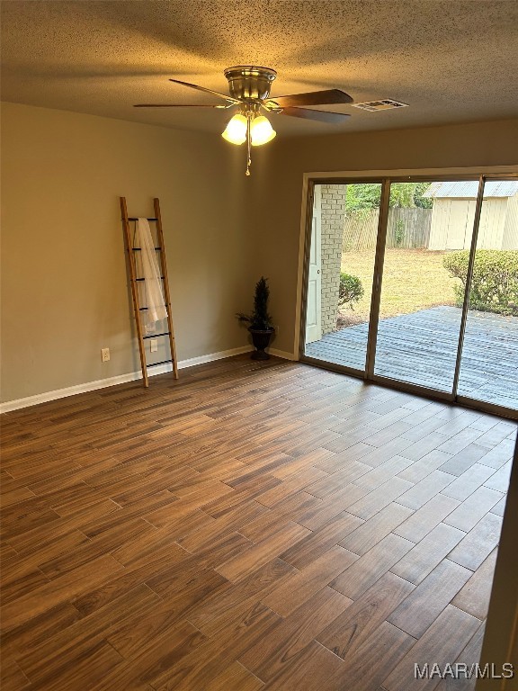 unfurnished room featuring wood-type flooring, a textured ceiling, and ceiling fan