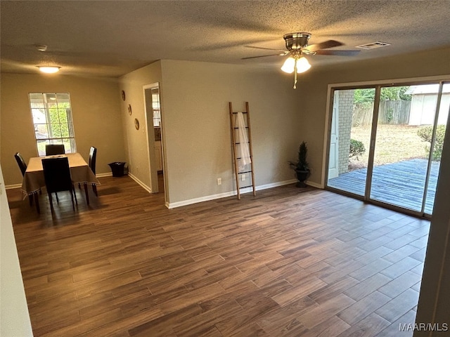 empty room featuring a textured ceiling, dark hardwood / wood-style flooring, and ceiling fan