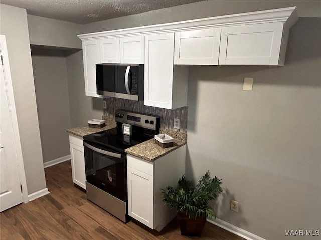 kitchen featuring a textured ceiling, dark wood-type flooring, white cabinetry, appliances with stainless steel finishes, and light stone countertops