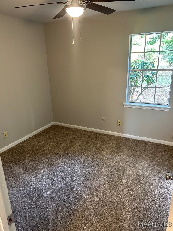 carpeted spare room with ceiling fan