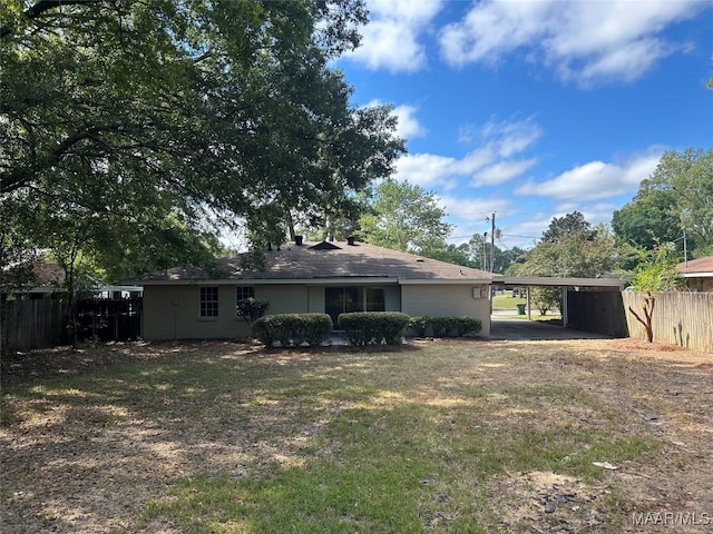 rear view of property with a carport