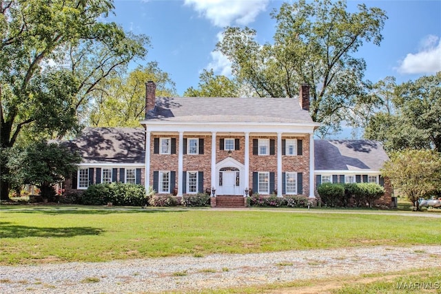 601 N Pickett St, Autaugaville, AL 36003 - neoclassical home with a chimney, a front lawn, and brick siding
