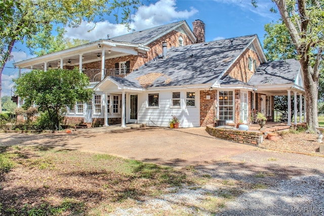 exterior space with a balcony and a porch