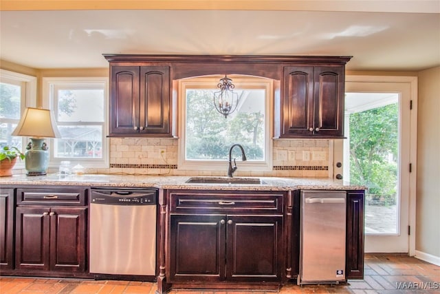 601 N Pickett St, Autaugaville, AL 36003 - kitchen with dark brown cabinets, tasteful backsplash, a sink, an inviting chandelier, and stainless steel dishwasher