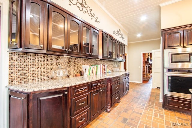 601 N Pickett St, Autaugaville, AL 36003 - kitchen with crown molding, light stone counters, tasteful backsplash, brick floor, and stainless steel appliances