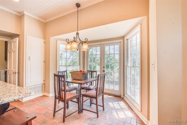 601 N Pickett St, Autaugaville, AL 36003 - dining room featuring brick floor, visible vents, a healthy amount of sunlight, and crown molding
