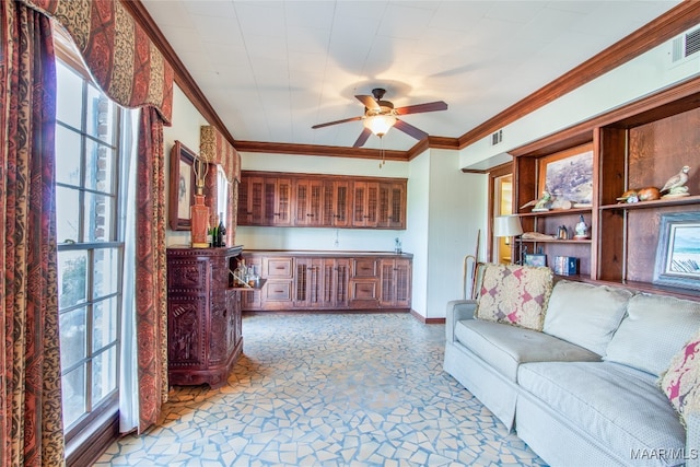 living room with ornamental molding and ceiling fan