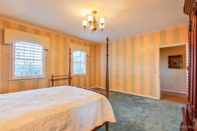 bedroom with a notable chandelier, ornamental molding, a textured ceiling, and carpet flooring