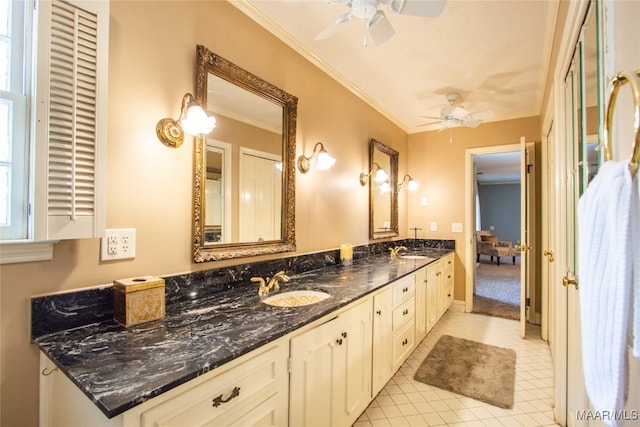 bathroom featuring ornamental molding, ceiling fan, and vanity