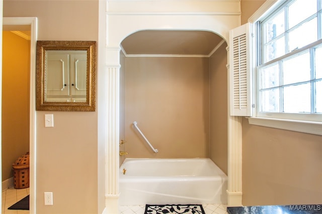 bathroom featuring ornamental molding, a tub, and tile patterned floors