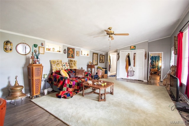 living room featuring lofted ceiling, ceiling fan, crown molding, and dark hardwood / wood-style flooring