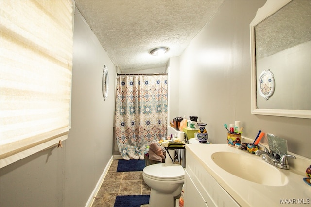 bathroom featuring tile patterned flooring, a textured ceiling, a shower with curtain, vanity, and toilet