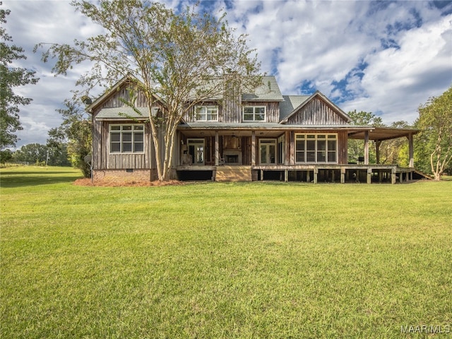 rear view of property featuring a yard