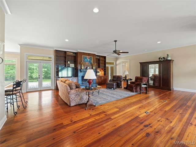 living room featuring ceiling fan, hardwood / wood-style flooring, and ornamental molding