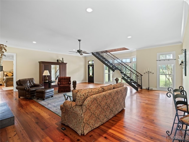 living room featuring hardwood / wood-style flooring, ceiling fan, and a wealth of natural light