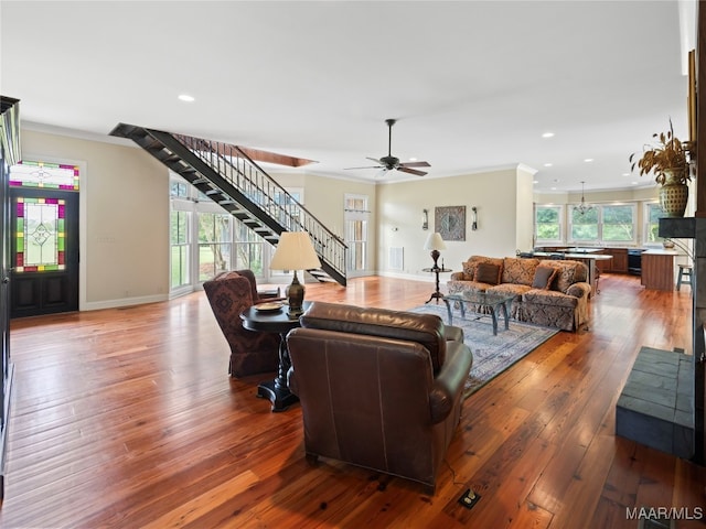 living room with crown molding, hardwood / wood-style floors, and ceiling fan