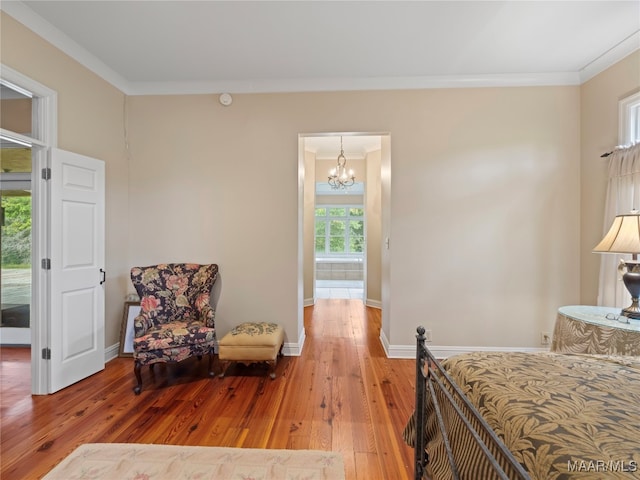 bedroom featuring crown molding, hardwood / wood-style floors, and a chandelier