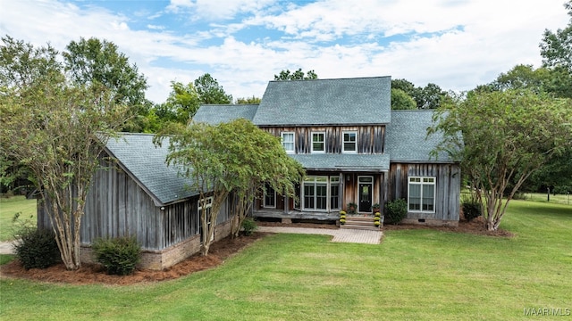 back of house featuring a porch and a lawn