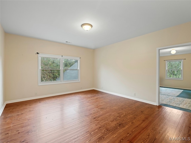 empty room featuring hardwood / wood-style flooring