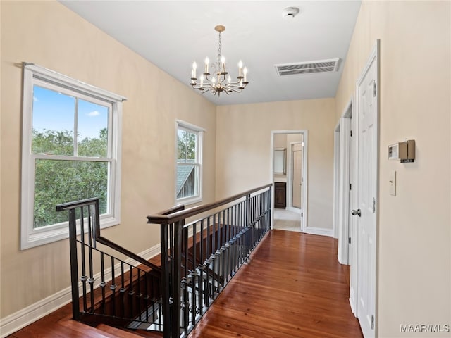 hallway with a chandelier and hardwood / wood-style flooring