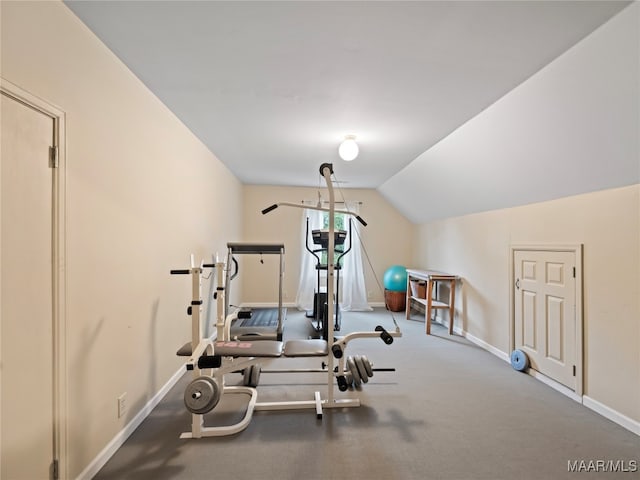 workout room with carpet floors and vaulted ceiling