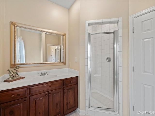 bathroom featuring vanity and a shower with door