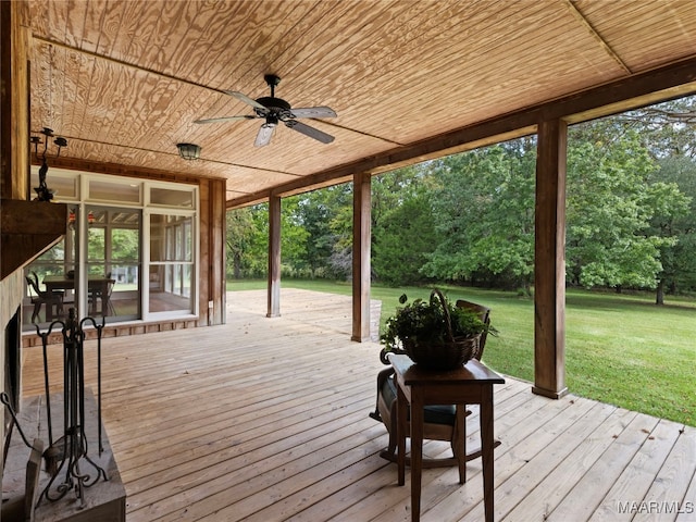 wooden deck featuring ceiling fan and a yard