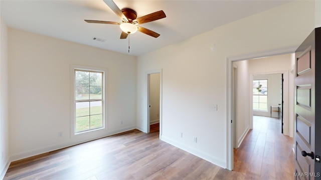 empty room featuring ceiling fan and light hardwood / wood-style floors